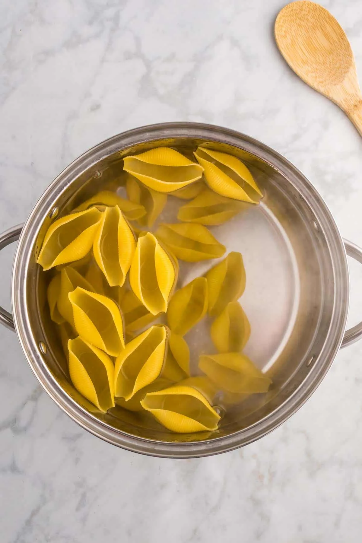 jumbo pasta shells cooking in a pot of water