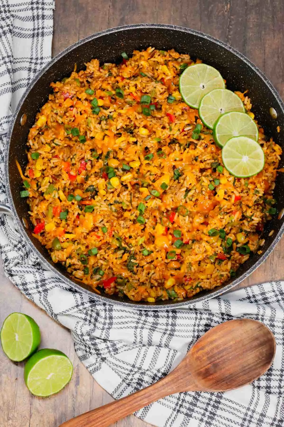 Cajun Ground Chicken and Rice is an easy weeknight dinner recipe loaded with long grain and wild rice, ground chicken, diced bell peppers, corn, chopped spinach, Cajun seasoning, green onions, ranch dressing and cheddar cheese.