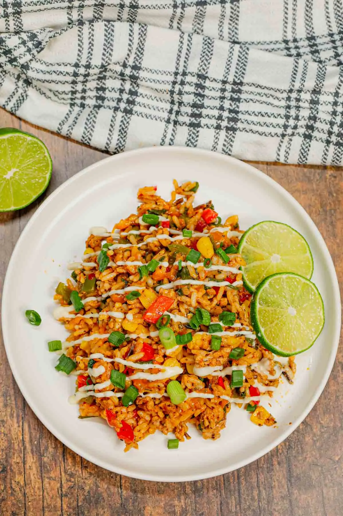 Cajun Ground Chicken and Rice is an easy weeknight dinner recipe loaded with long grain and wild rice, ground chicken, diced bell peppers, corn, chopped spinach, Cajun seasoning, green onions, ranch dressing and cheddar cheese.