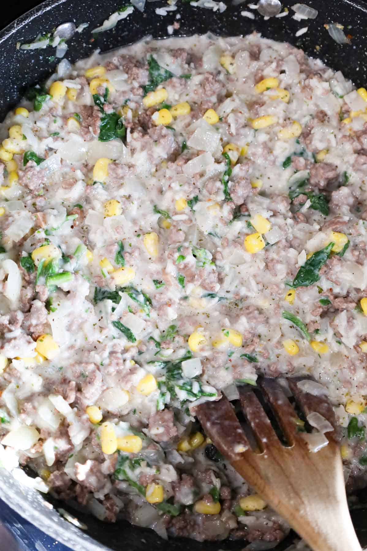 creamy ground beef, spinach and corn mixture in a skillet