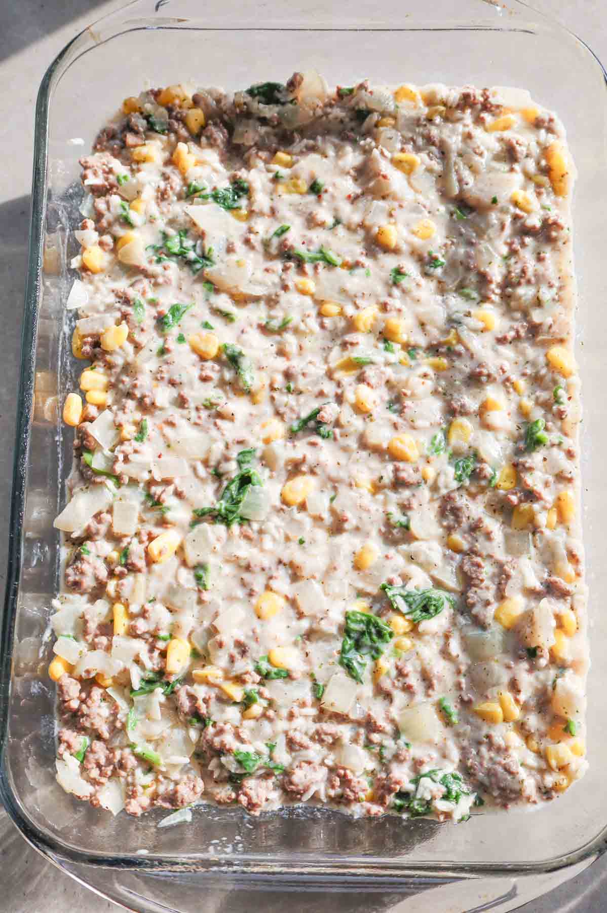 creamy ground beef, rice and vegetable mixture in a baking dish