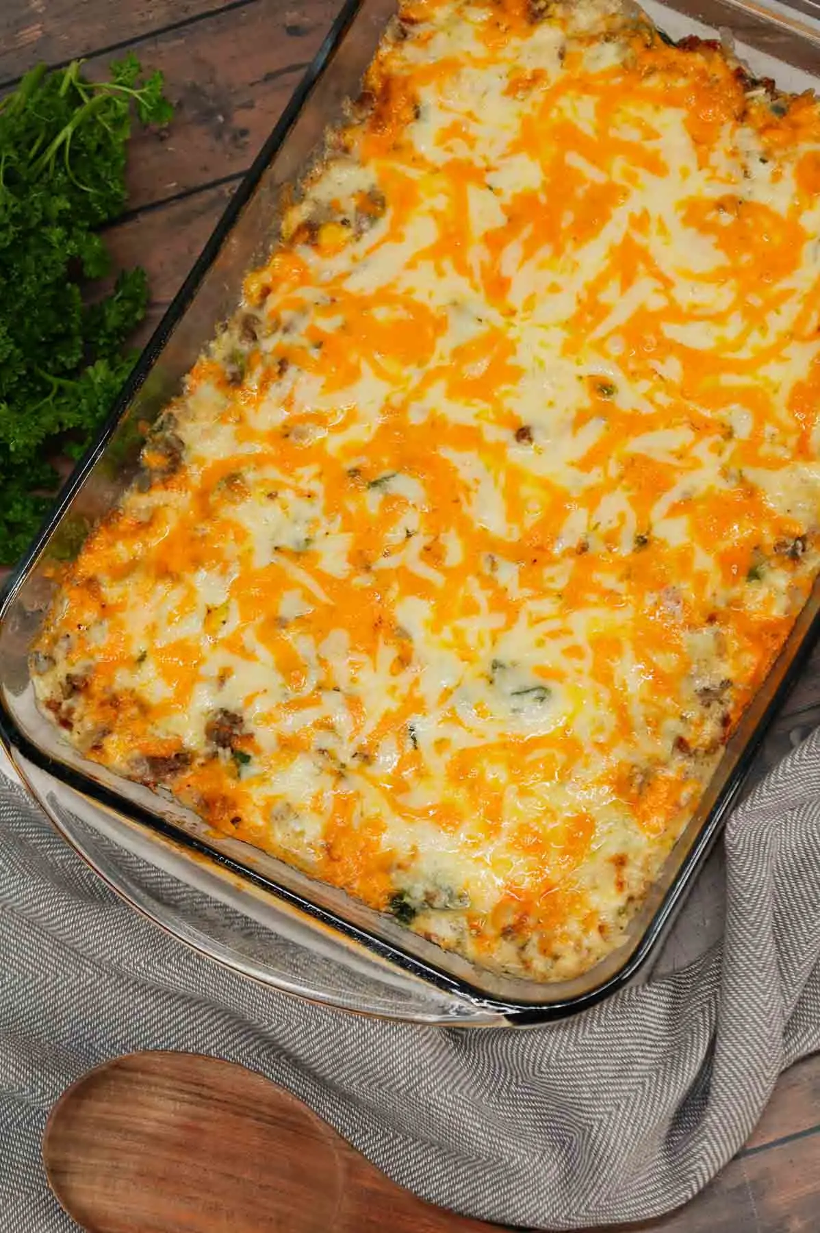 Cheesy Hamburger Rice Casserole is a hearty casserole loaded with ground beef, instant rice, frozen chopped spinach, corn, cream of mushroom soup, shredded cheddar and mozzarella cheese.