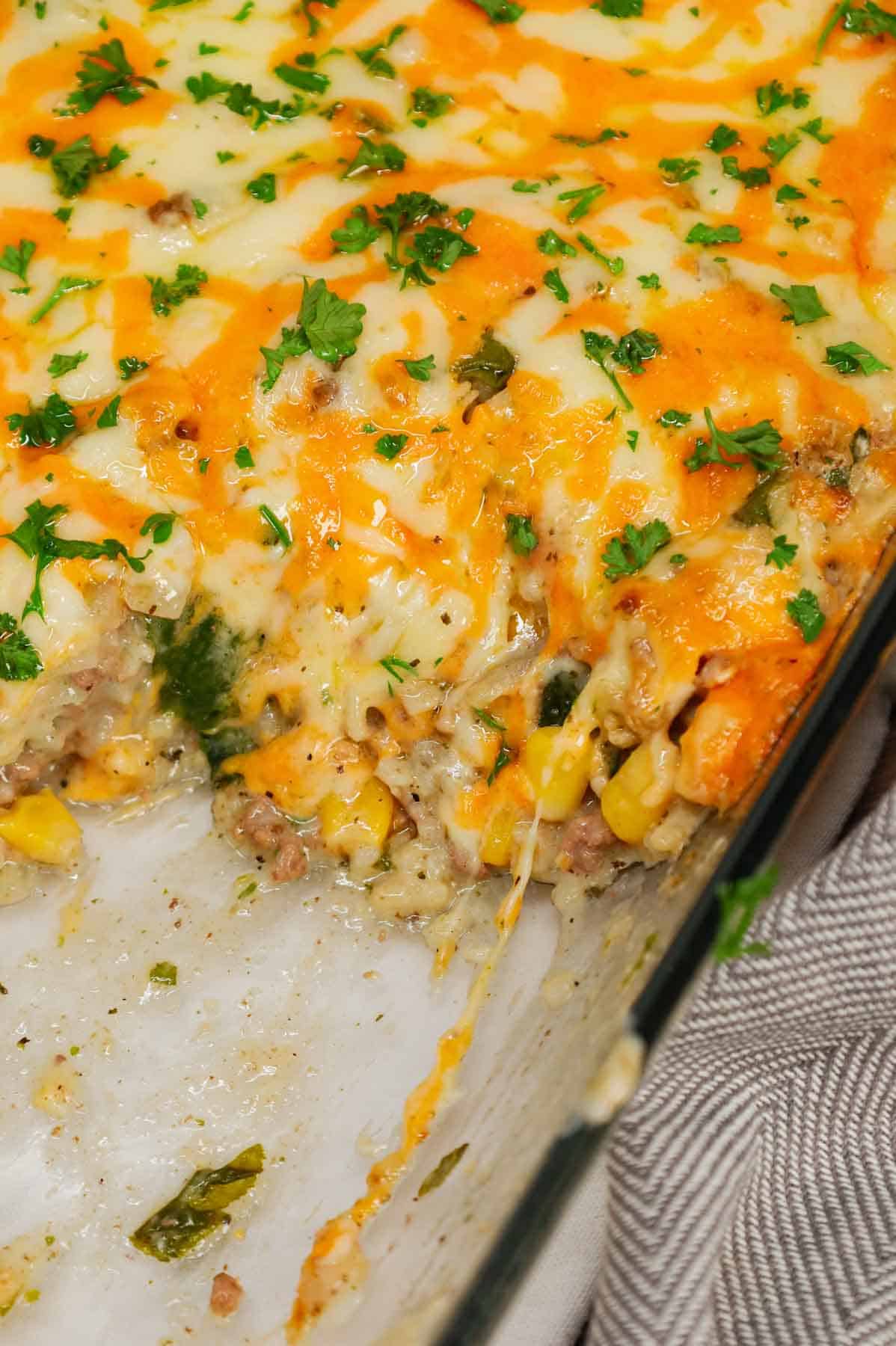 Cheesy Hamburger Rice Casserole is a hearty casserole loaded with ground beef, instant rice, frozen chopped spinach, corn, cream of mushroom soup, shredded cheddar and mozzarella cheese.