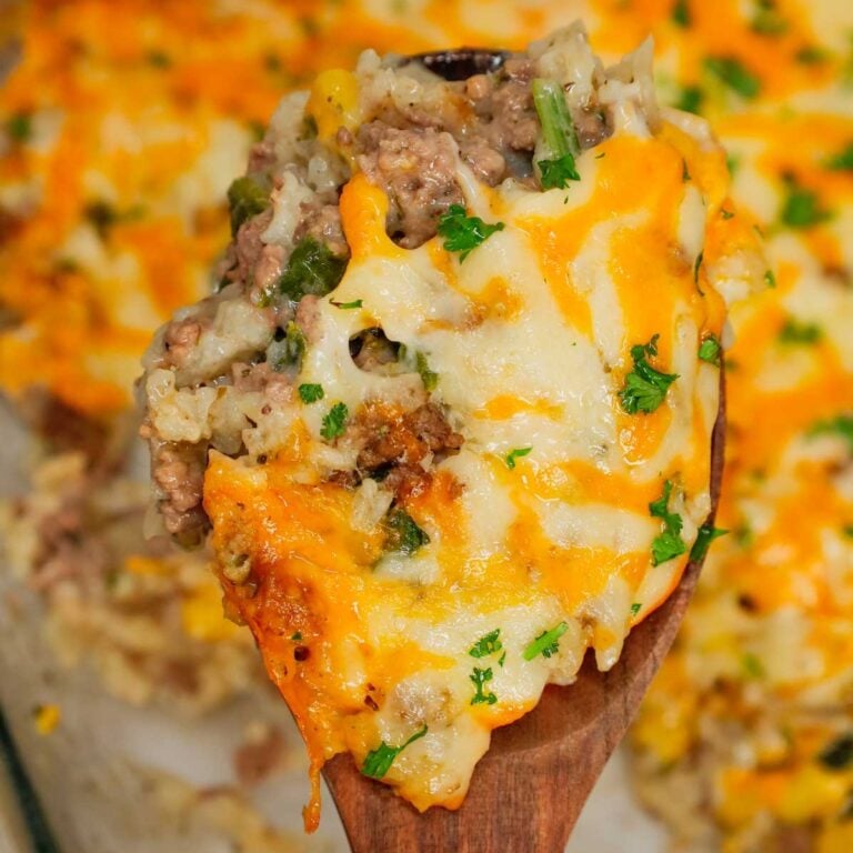 Cheesy Hamburger Rice Casserole is a hearty casserole loaded with ground beef, instant rice, frozen chopped spinach, corn, cream of mushroom soup, shredded cheddar and mozzarella cheese.