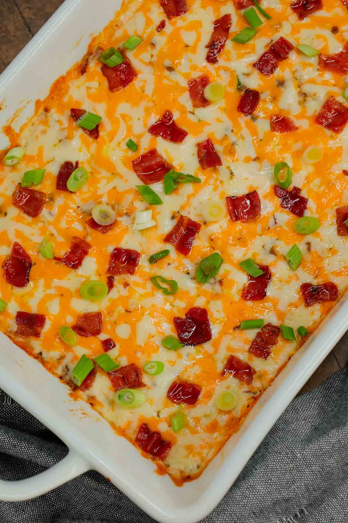 Cheesy Ranch Ground Beef and Rice Casserole is a hearty dinner recipe loaded with ground beef, instant rice, bacon, cheddar soup, milk, ranch dressing mix, chopped green onions and shredded cheese.