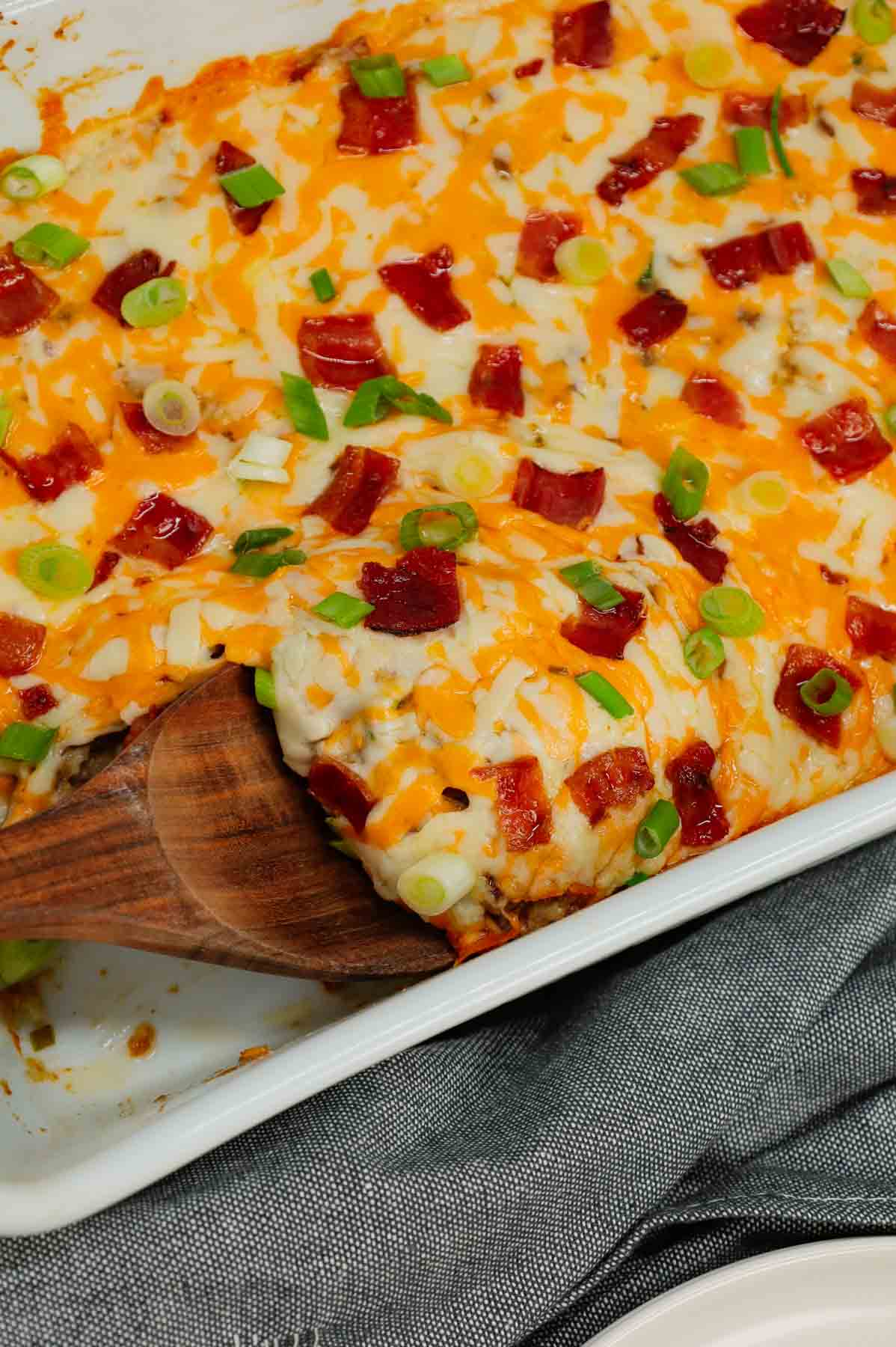 Cheesy Ranch Ground Beef and Rice Casserole is a hearty dinner recipe loaded with ground beef, instant rice, bacon, cheddar soup, milk, ranch dressing mix, chopped green onions and shredded cheese.