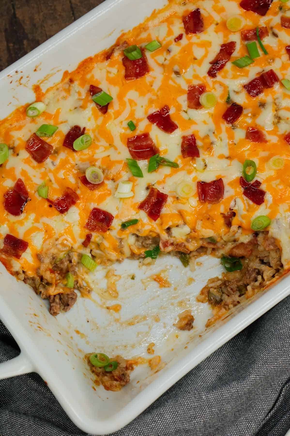 Cheesy Ranch Ground Beef and Rice Casserole is a hearty dinner recipe loaded with ground beef, instant rice, bacon, cheddar soup, milk, ranch dressing mix, chopped green onions and shredded cheese.