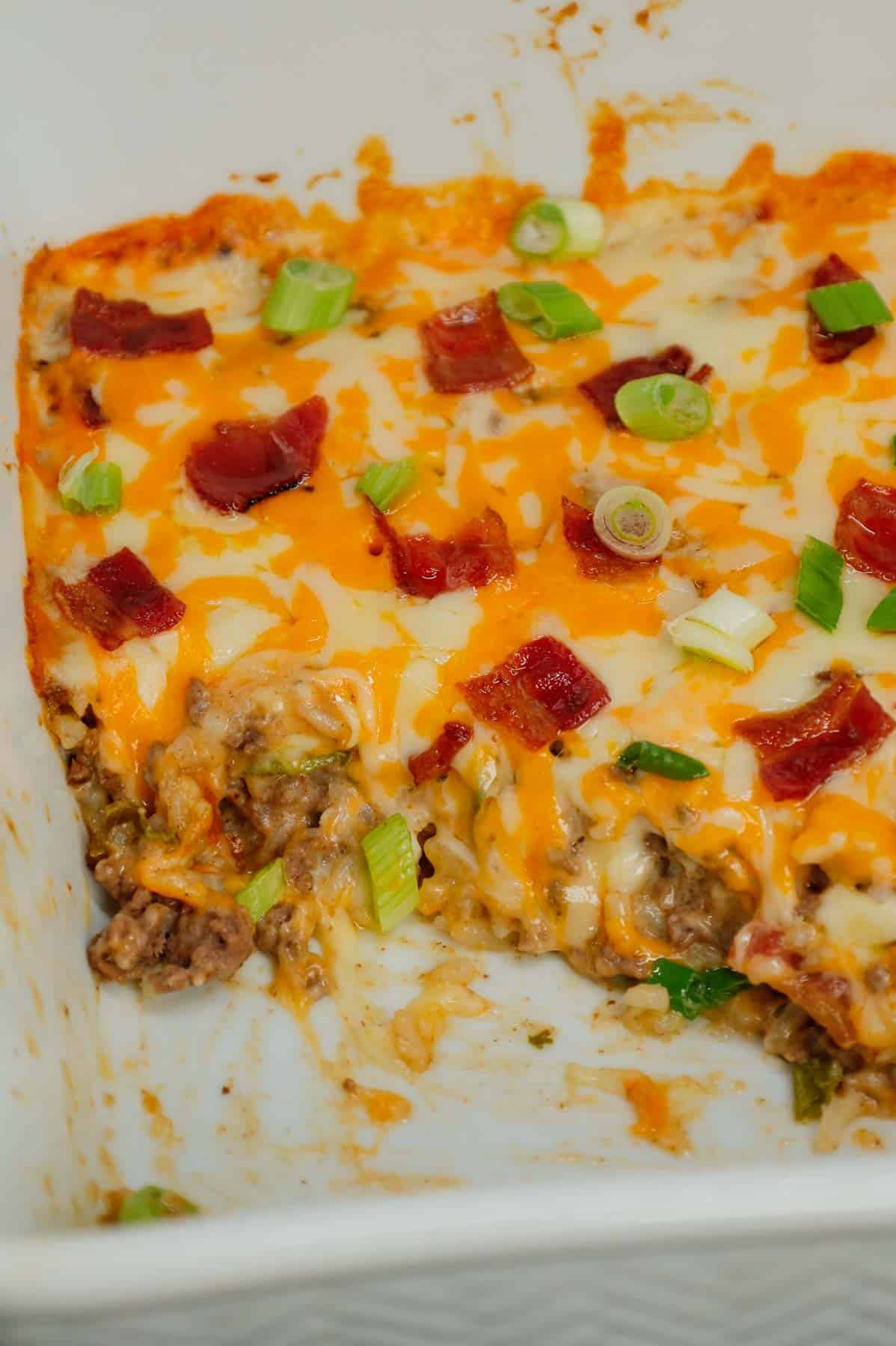 Cheesy Ranch Ground Beef and Rice Casserole is a hearty dinner recipe loaded with ground beef, instant rice, bacon, cheddar soup, milk, ranch dressing mix, chopped green onions and shredded cheese.