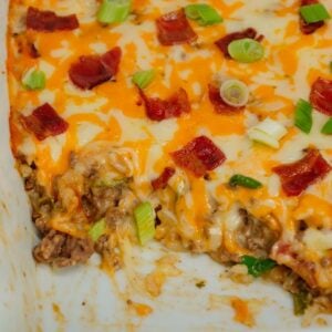 Cheesy Ranch Ground Beef and Rice Casserole is a hearty dinner recipe loaded with ground beef, instant rice, bacon, cheddar soup, milk, ranch dressing mix, chopped green onions and shredded cheese.