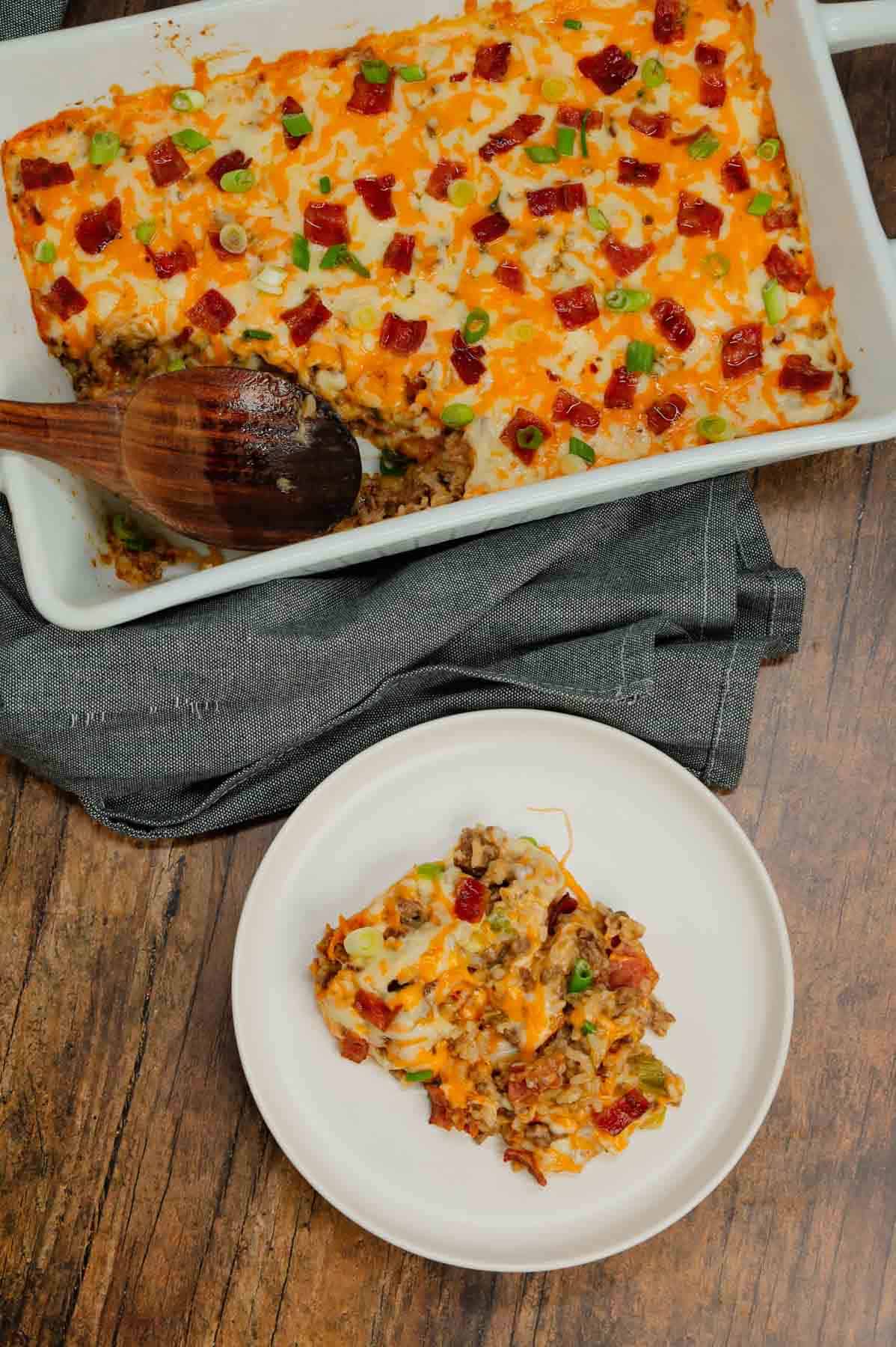 Cheesy Ranch Ground Beef and Rice Casserole is a hearty dinner recipe loaded with ground beef, instant rice, bacon, cheddar soup, milk, ranch dressing mix, chopped green onions and shredded cheese.