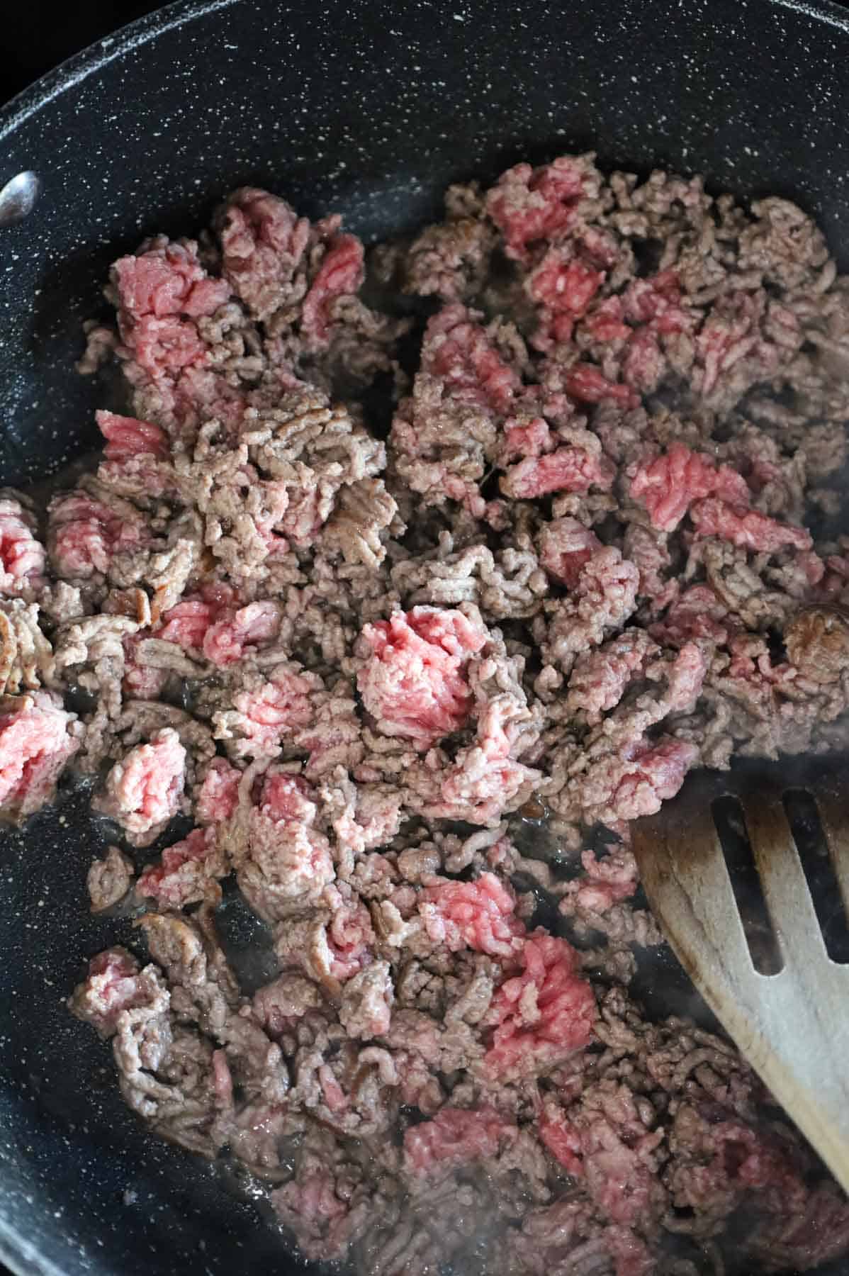 lean ground beef cooking in a skillet