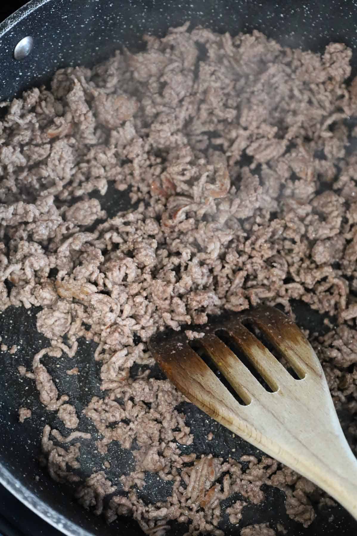 ground beef cooking in a skillet