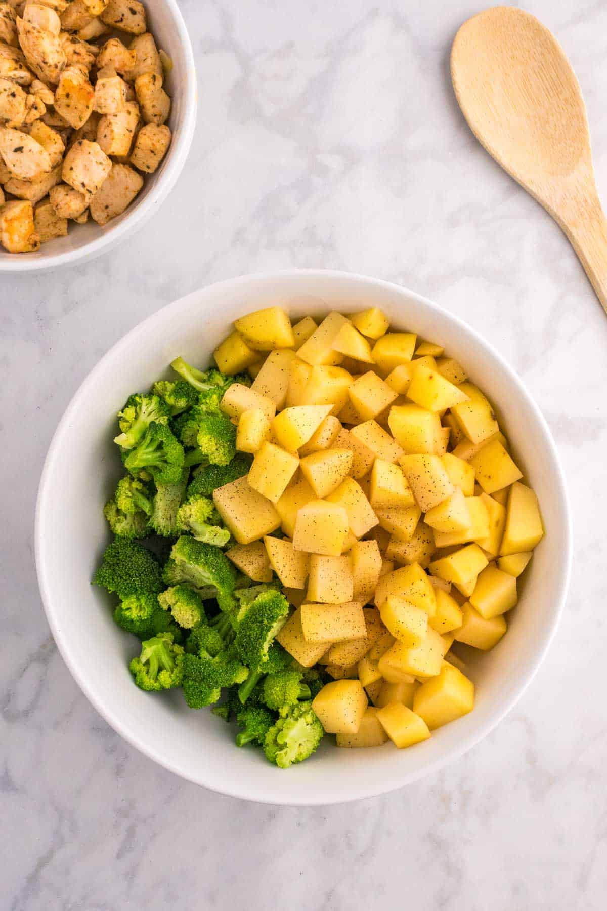 broccoli florets and cubed potatoes in a bowl