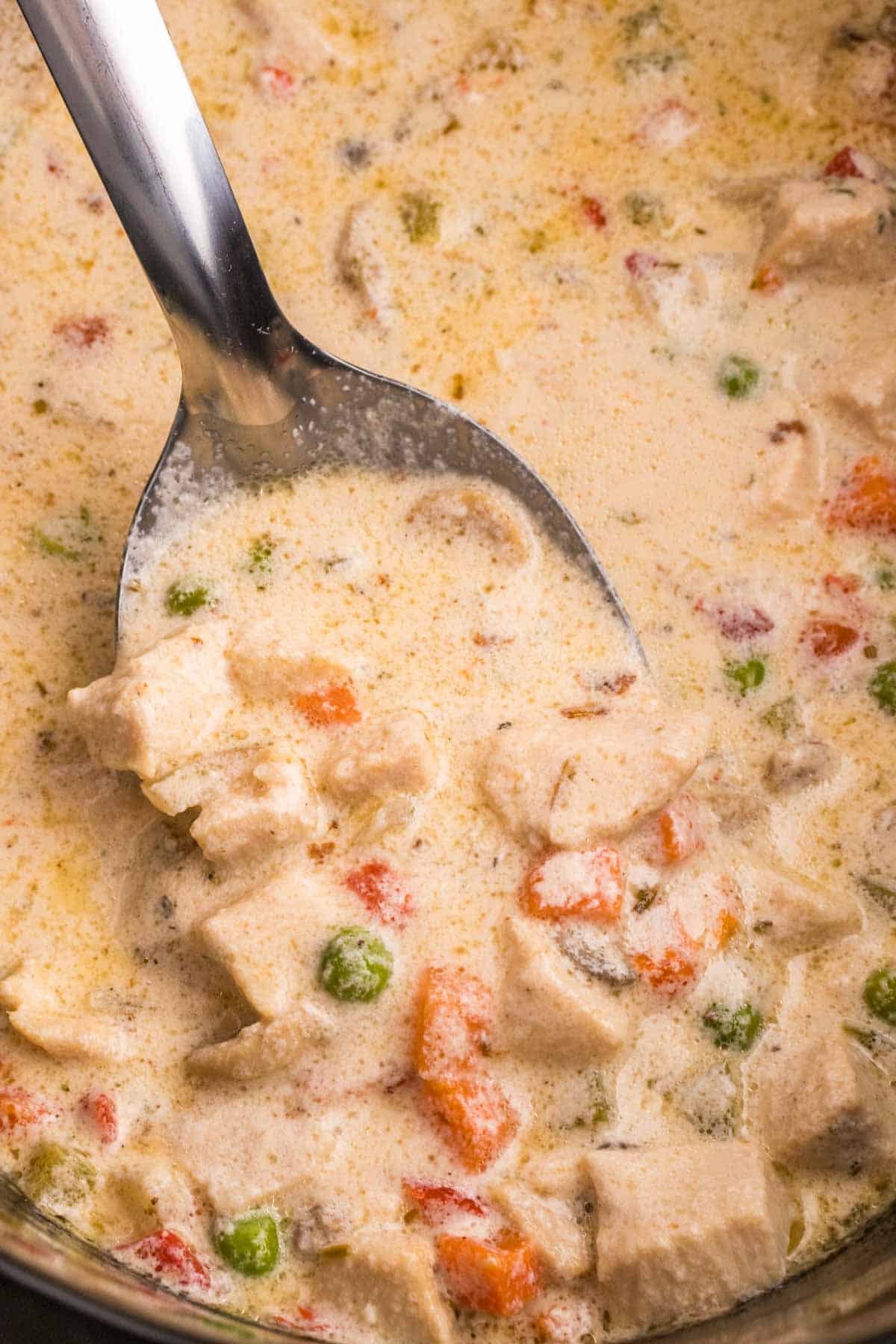 Crock Pot Chicken a la King is an easy slow cooker chicken dinner recipe loaded with chunks of chicken, bell peppers, mushrooms, peas, carrots and pimentos all in a creamy sauce that can be served over biscuits, rice or noodles.