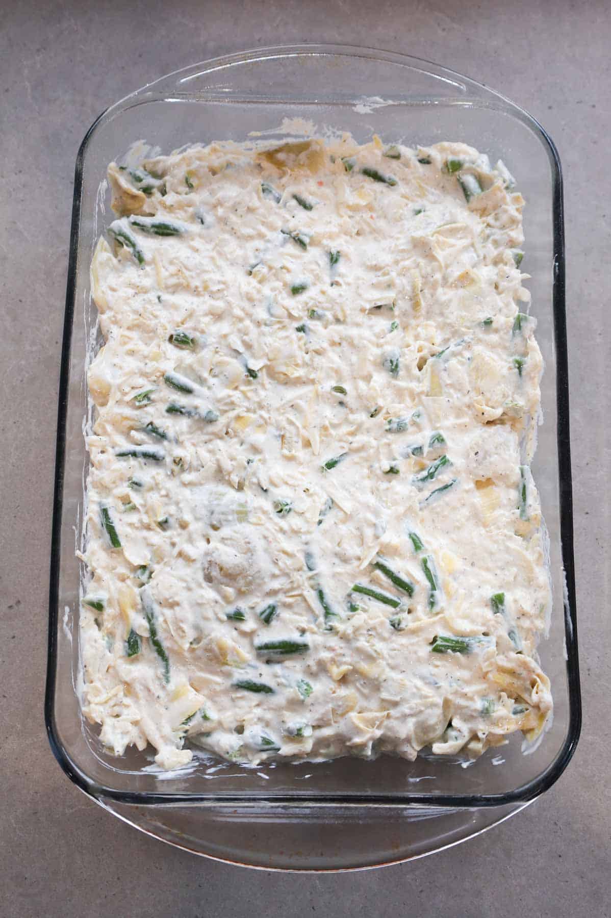 creamy green bean and artichoke mixture in a baking dish