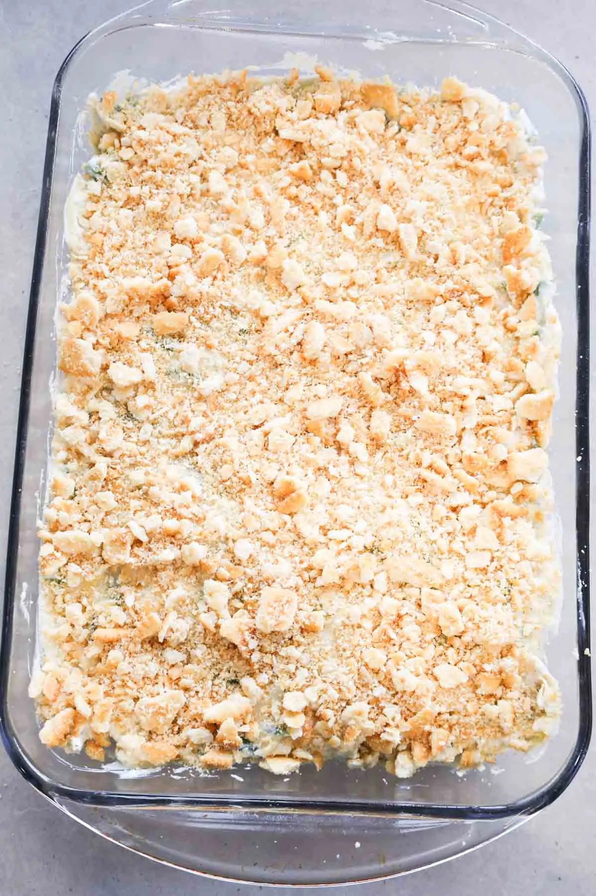 crushed Ritz cracker on top of green bean mixture in a baking dish