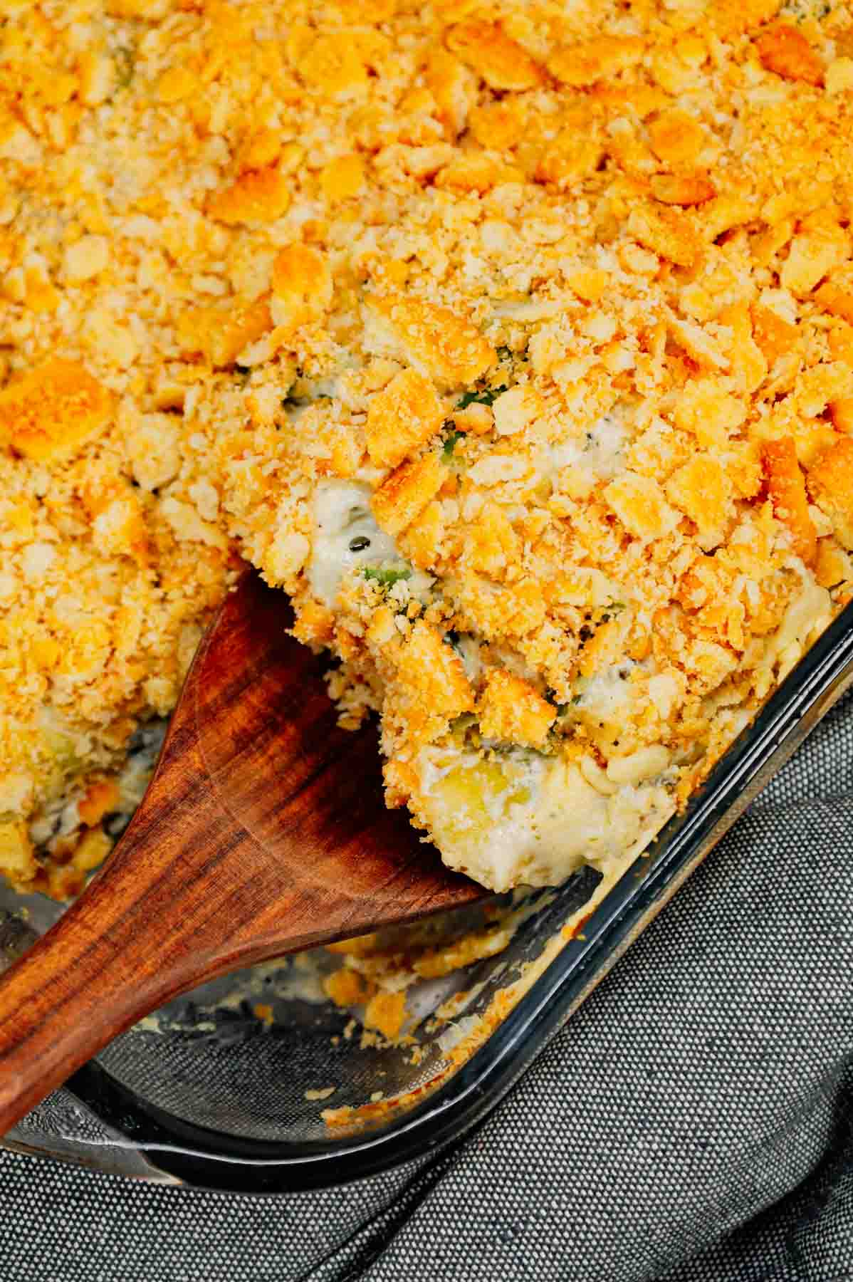 Green Bean Artichoke Casserole is a delicious holiday side dish recipe loaded with cut green beans, artichoke hears, cream cheese, sour cream, mozzarella cheese and parmesan cheese with a crushed Ritz cracker topping.