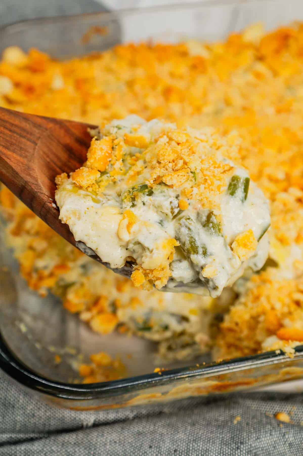 Green Bean Artichoke Casserole is a delicious holiday side dish recipe loaded with cut green beans, artichoke hears, cream cheese, sour cream, mozzarella cheese and parmesan cheese with a crushed Ritz cracker topping.