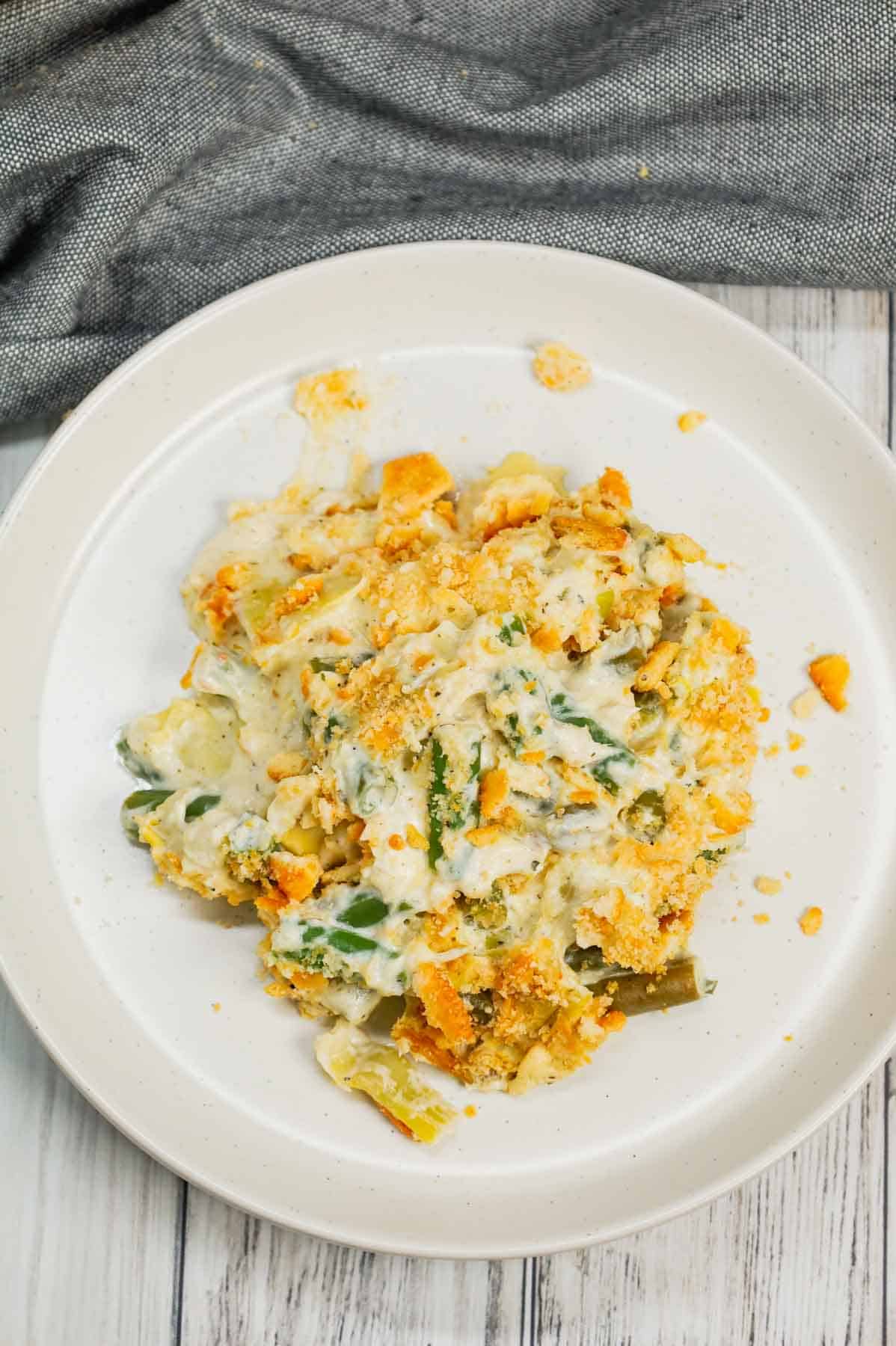 Green Bean Artichoke Casserole is a delicious holiday side dish recipe loaded with cut green beans, artichoke hears, cream cheese, sour cream, mozzarella cheese and parmesan cheese with a crushed Ritz cracker topping.