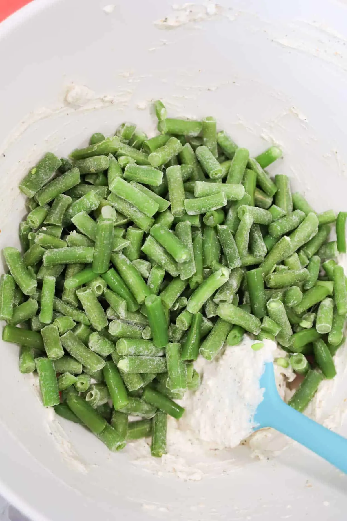 cut green beans added to bowl with cream cheese and sour cream mixture