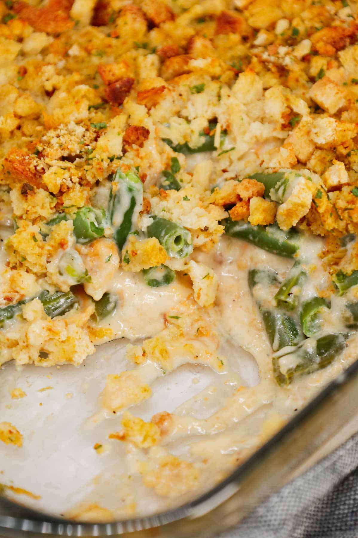 Green Bean Stuffing Casserole is a tasty side dish recipe made with frozen cut green beans, cream of mushroom soup, sour cream, French's crispy fried onions, shredded cheddar cheese, chicken broth and topped with stove top stuffing mix.