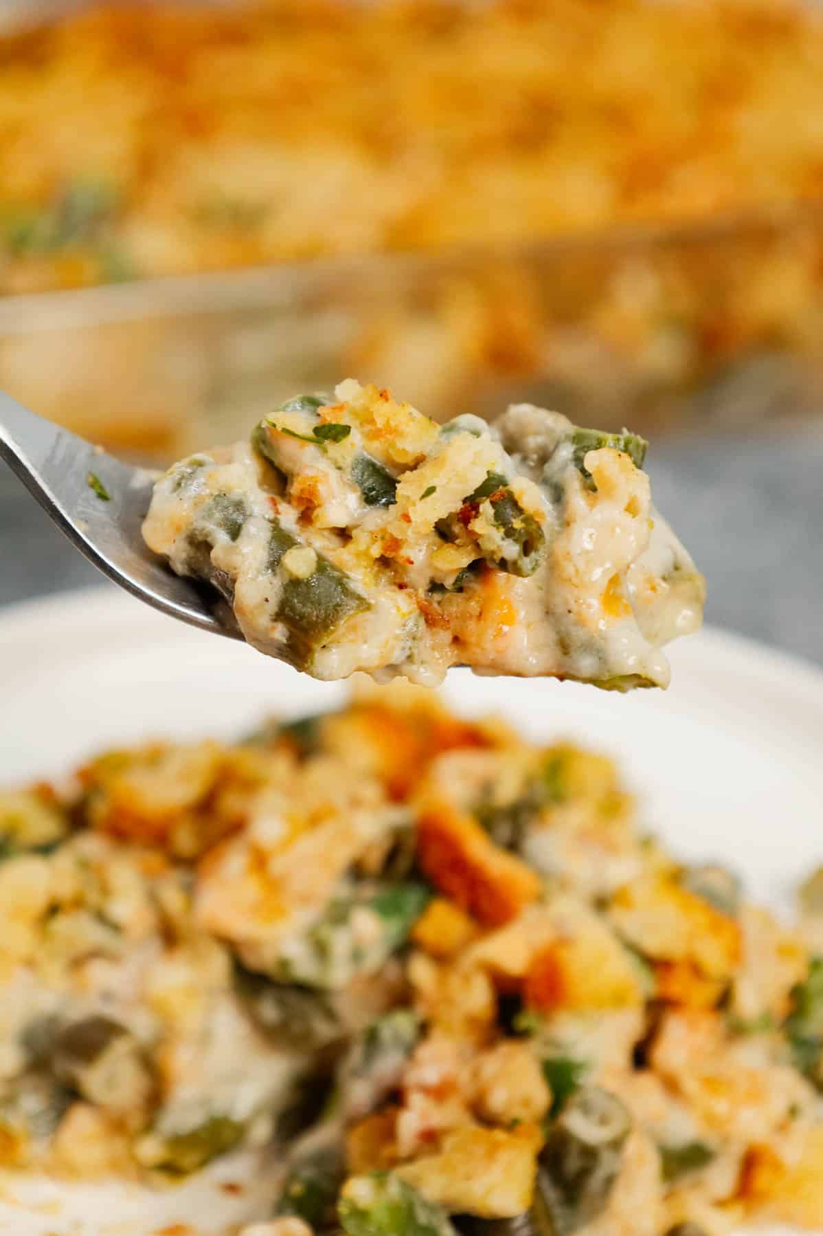 Green Bean Stuffing Casserole is a tasty side dish recipe made with frozen cut green beans, cream of mushroom soup, sour cream, French's crispy fried onions, shredded cheddar cheese, chicken broth and topped with stove top stuffing mix.