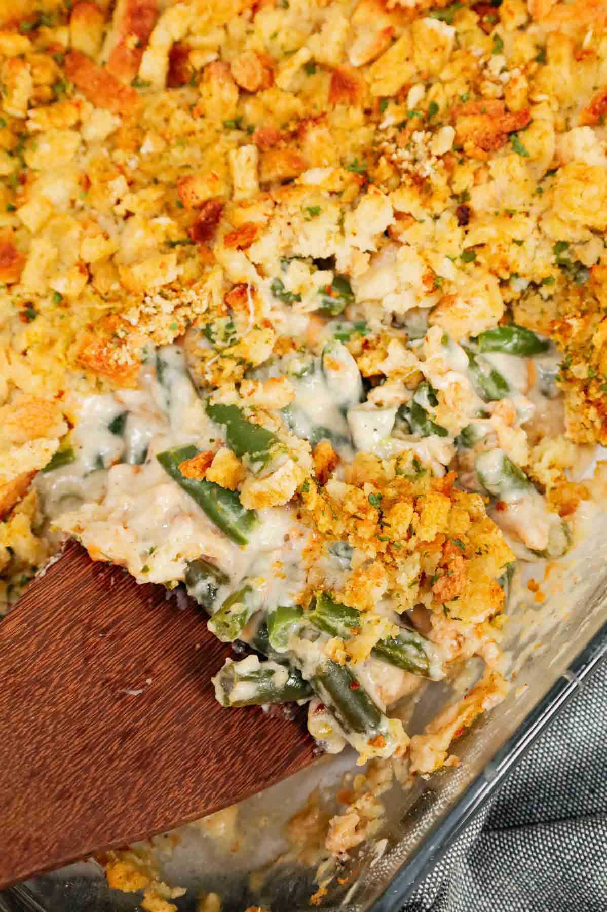 Green Bean Stuffing Casserole is a tasty side dish recipe made with frozen cut green beans, cream of mushroom soup, sour cream, French's crispy fried onions, shredded cheddar cheese, chicken broth and topped with stove top stuffing mix.