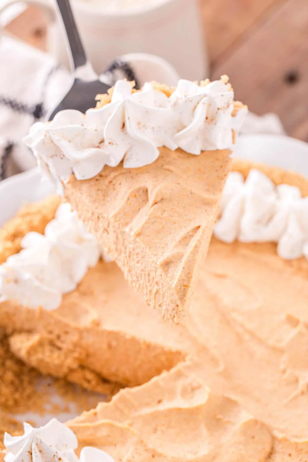 Marshmallow Pumpkin Pie is a delicious no bake pumpkin pie recipe with a graham crust and a filling made from marshmallow fluff, pumpkin puree and Cool Whip.