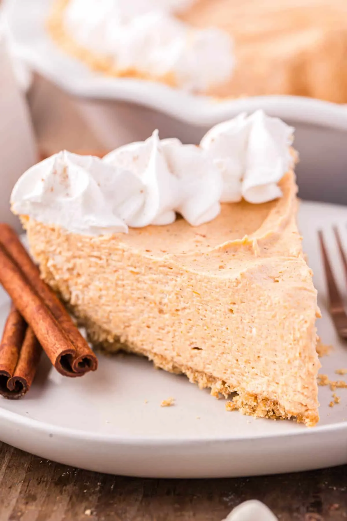 Marshmallow Pumpkin Pie is a delicious no bake pumpkin pie recipe with a graham crust and a filling made from marshmallow fluff, pumpkin puree and Cool Whip.