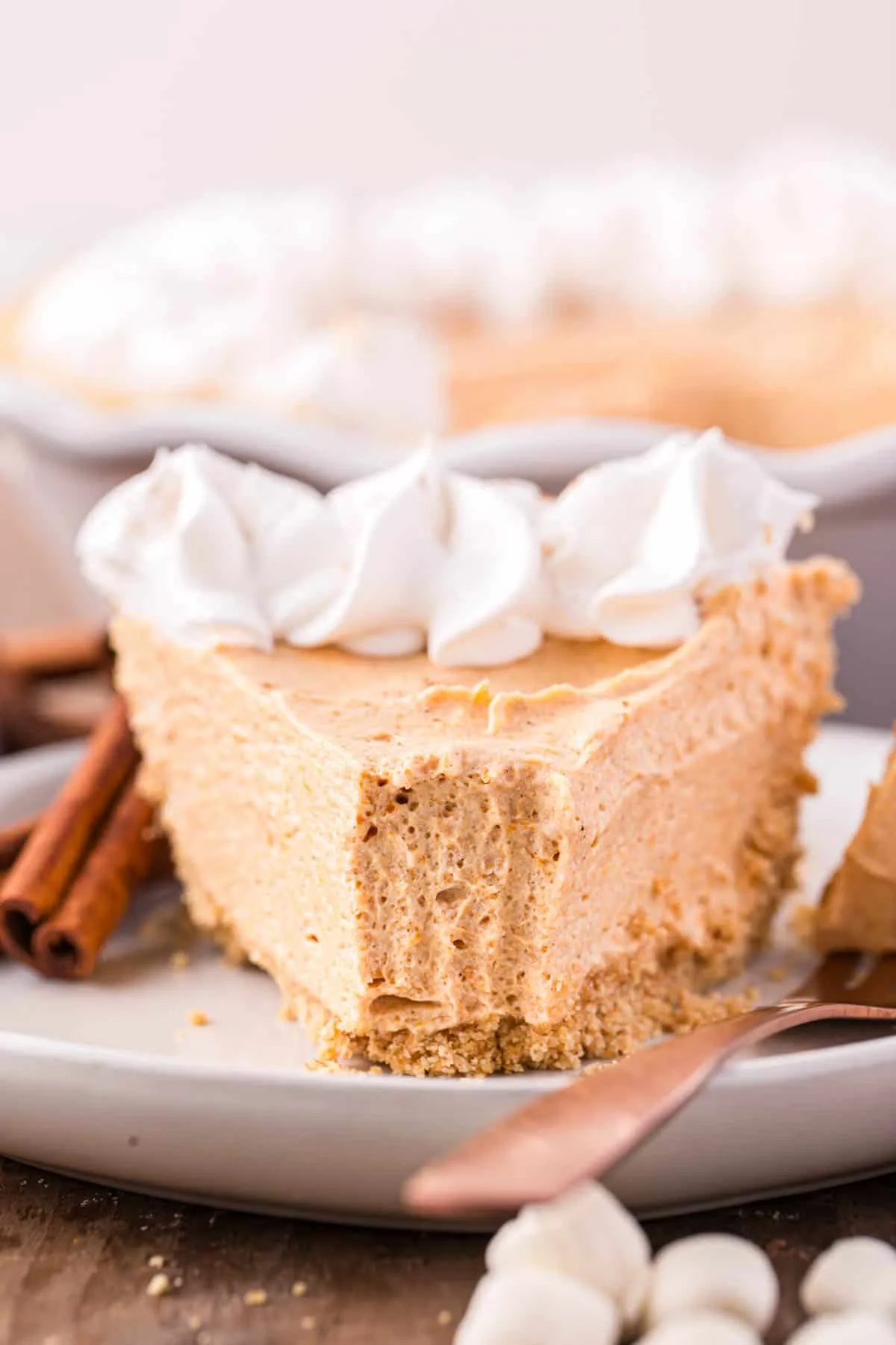 Marshmallow Pumpkin Pie is a delicious no bake pumpkin pie recipe with a graham crust and a filling made from marshmallow fluff, pumpkin puree and Cool Whip.