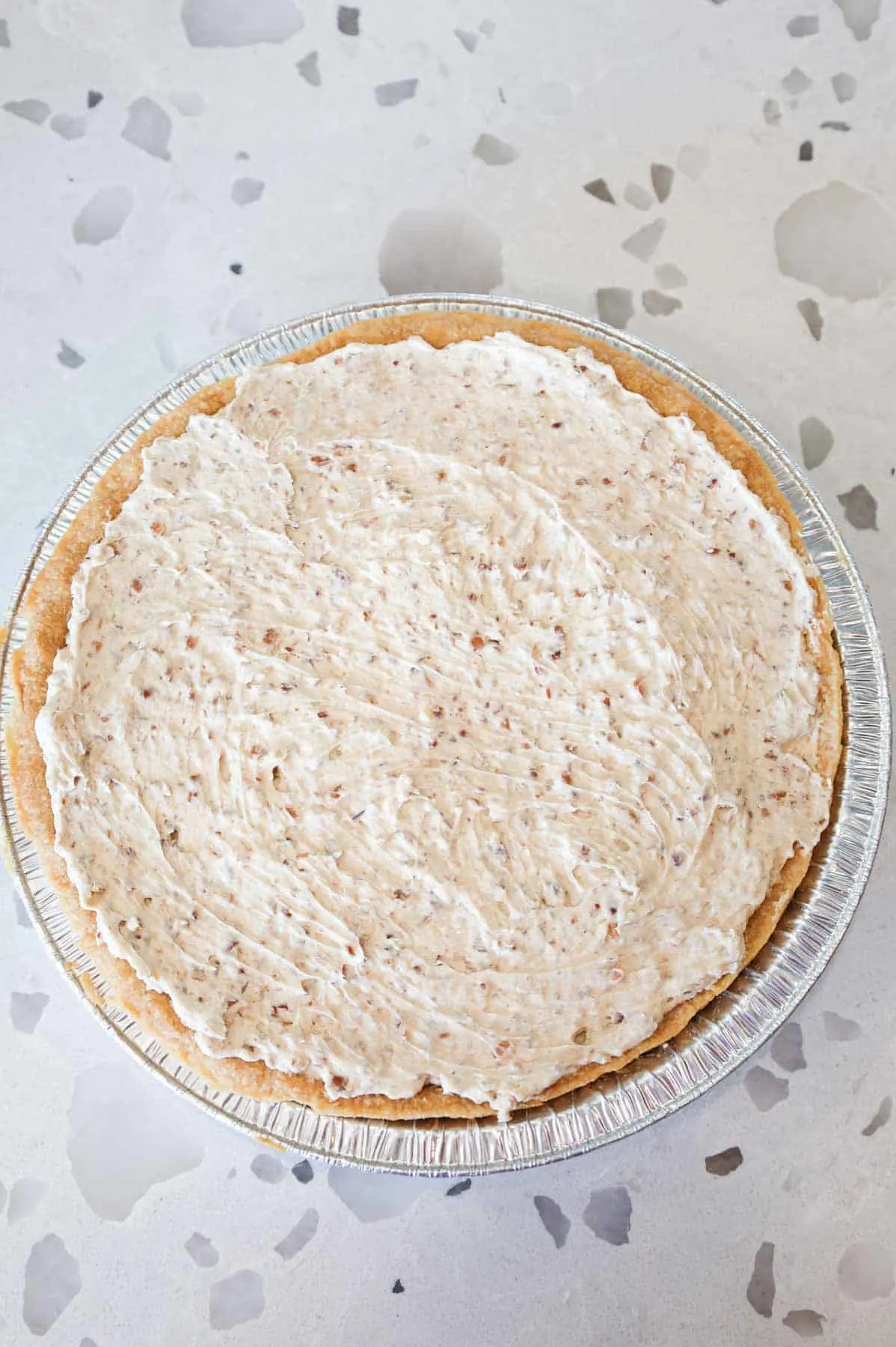 pecan cream filling in a baked pie crust