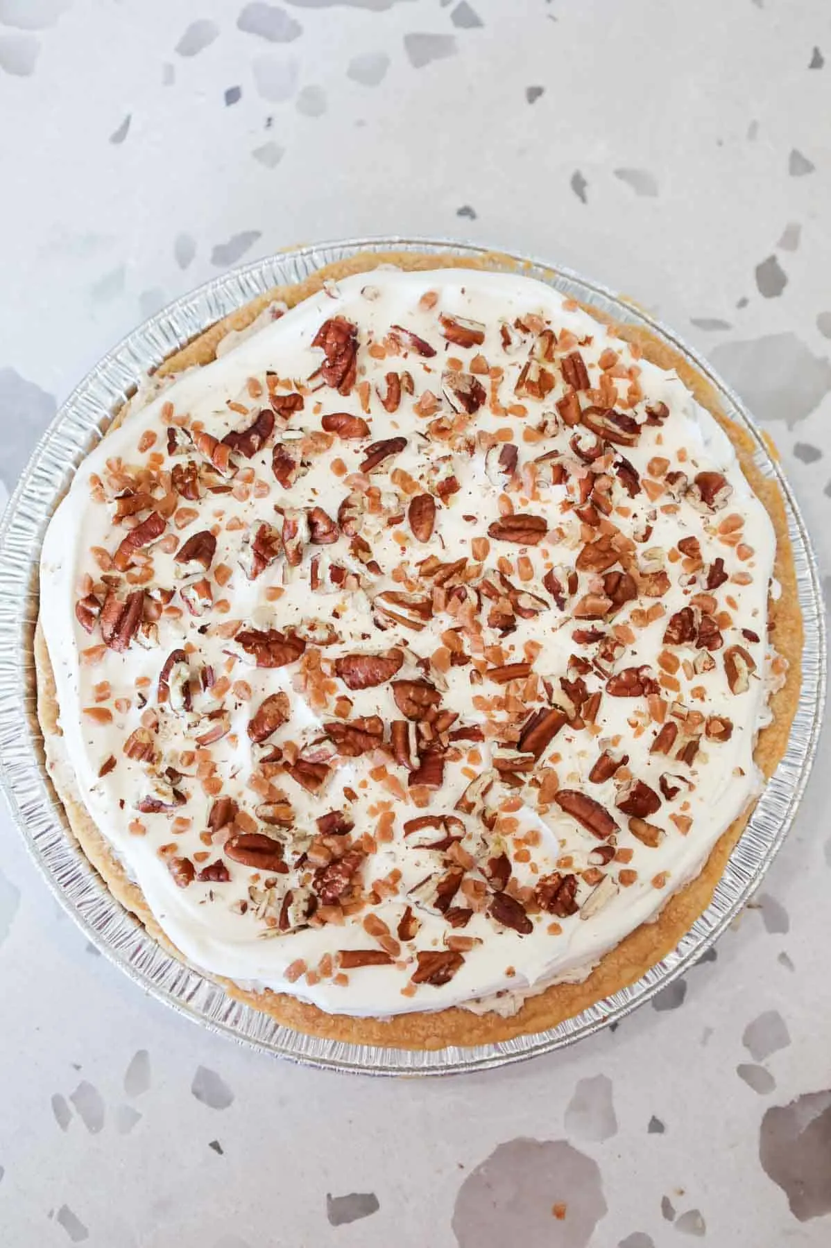toffee bits and pecan pieces on top of cream pie
