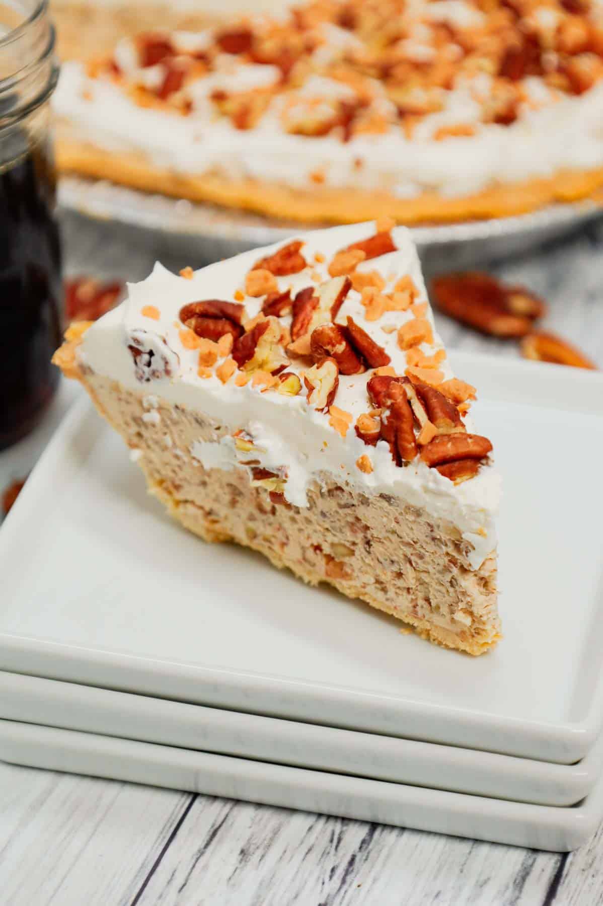 Pecan Cream Pie is an easy dessert recipe using a store bought pie crust and a filling made from cream cheese, crushed pecans, toffee bits, maple syrup, brown sugar and Cool Whip.