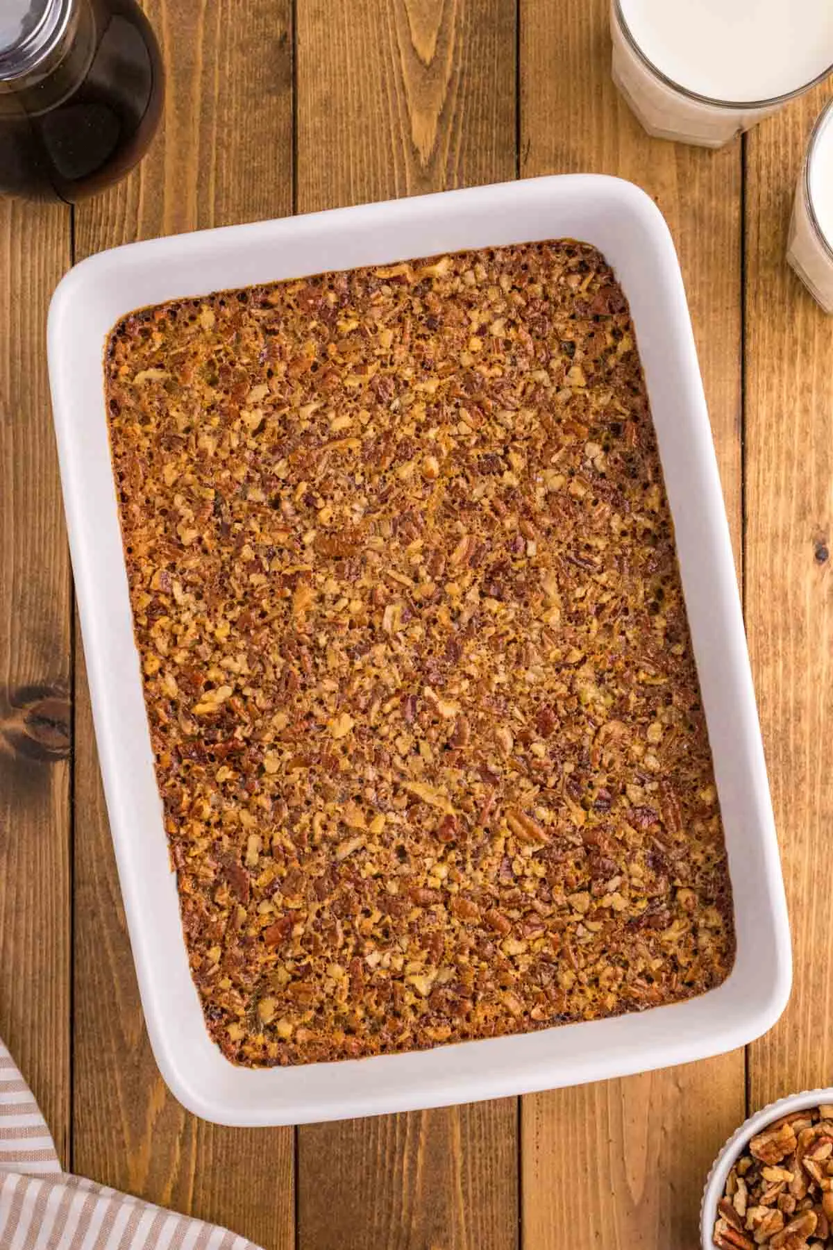 Pecan Pie Bars are delicious dessert bars with a shortbread base topped with a pecan pie filling layer made with eggs, maple syrup, corn syrup, brown sugar, butter and chopped pecans.