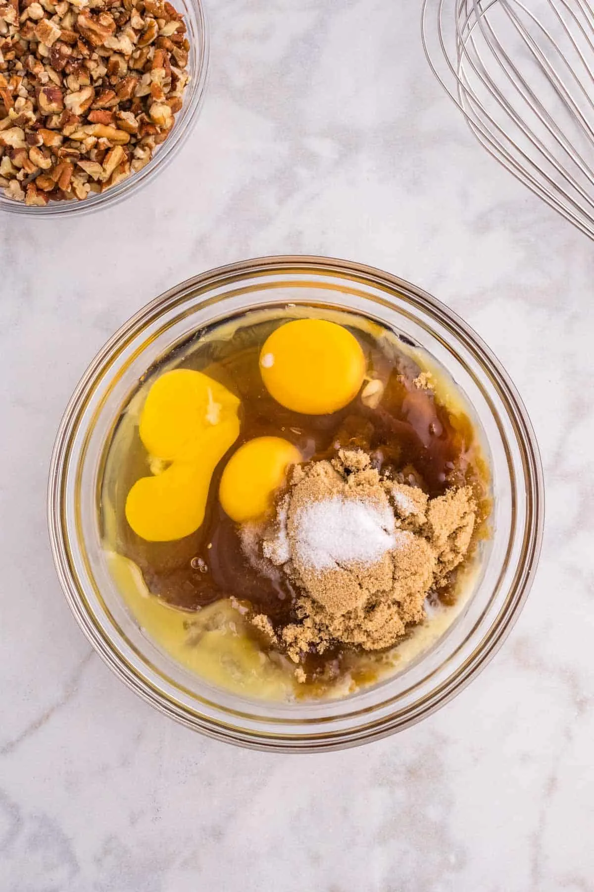 eggs, brown sugar, salt, corn syrup and maple syrup in a bowl