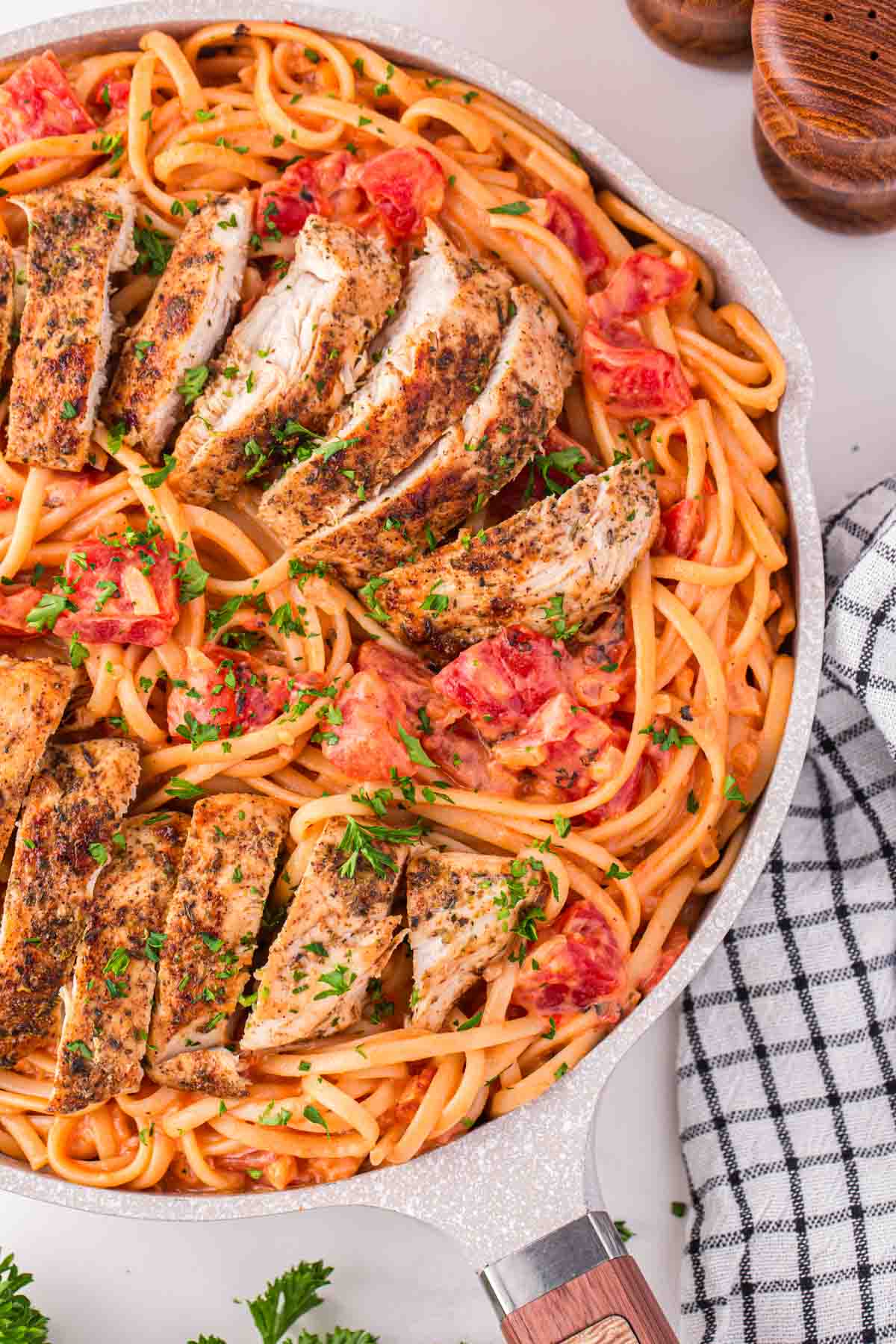 Spicy Chicken Pasta is a hearty dinner recipe loaded with strips of seasoned chicken breast, linguine, fire roasted tomatoes, chili flakes and heavy cream.