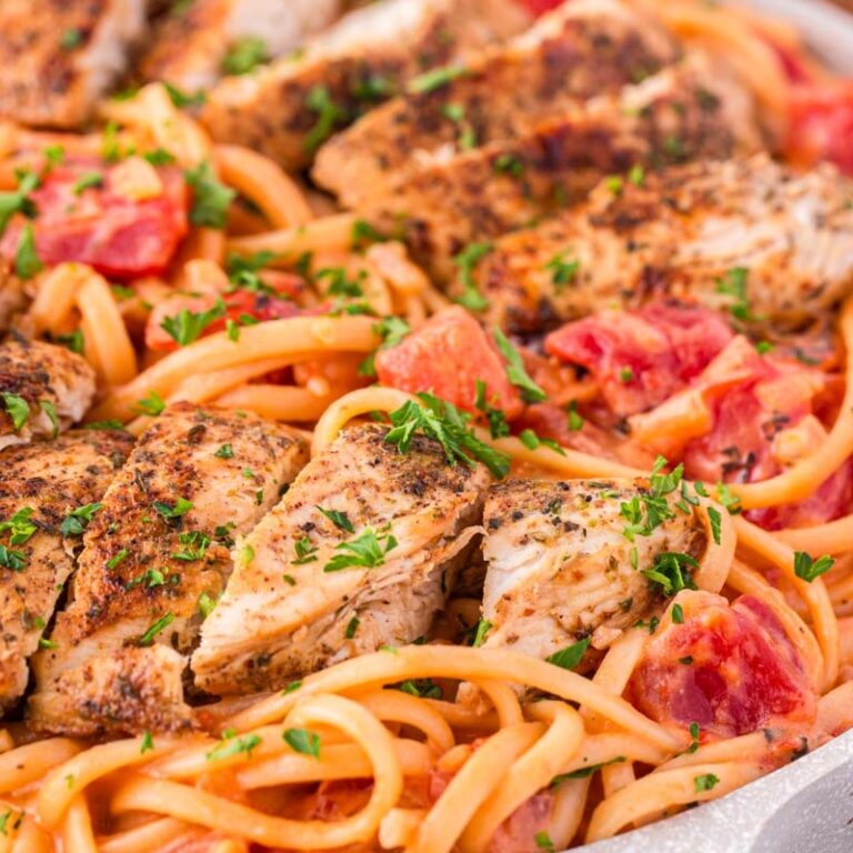 Spicy Chicken Pasta is a hearty dinner recipe loaded with strips of seasoned chicken breast, linguine, fire roasted tomatoes, chili flakes and heavy cream.