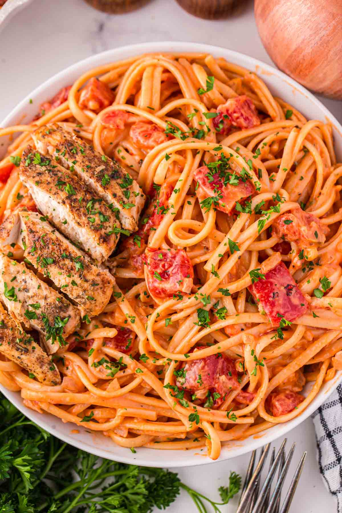 Spicy Chicken Pasta is a hearty dinner recipe loaded with strips of seasoned chicken breast, linguine, fire roasted tomatoes, chili flakes and heavy cream.