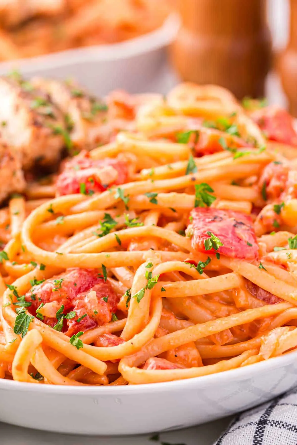 Spicy Chicken Pasta is a hearty dinner recipe loaded with strips of seasoned chicken breast, linguine, fire roasted tomatoes, chili flakes and heavy cream.