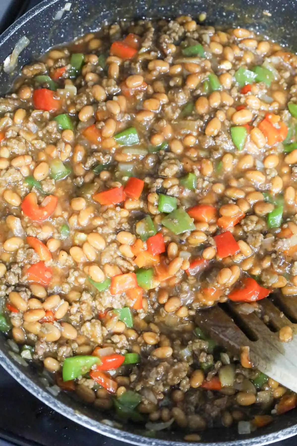 ground beef, bell pepper, beans and barbecue sauce mixture in a skillet