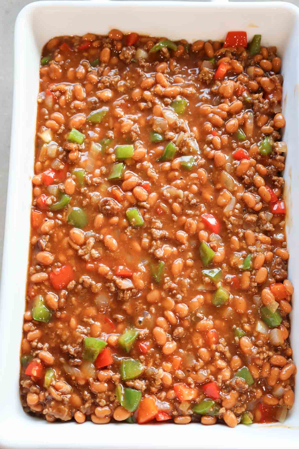 ground beef, bell peppers, baked bean and barbecue sauce mixture in a baking dish