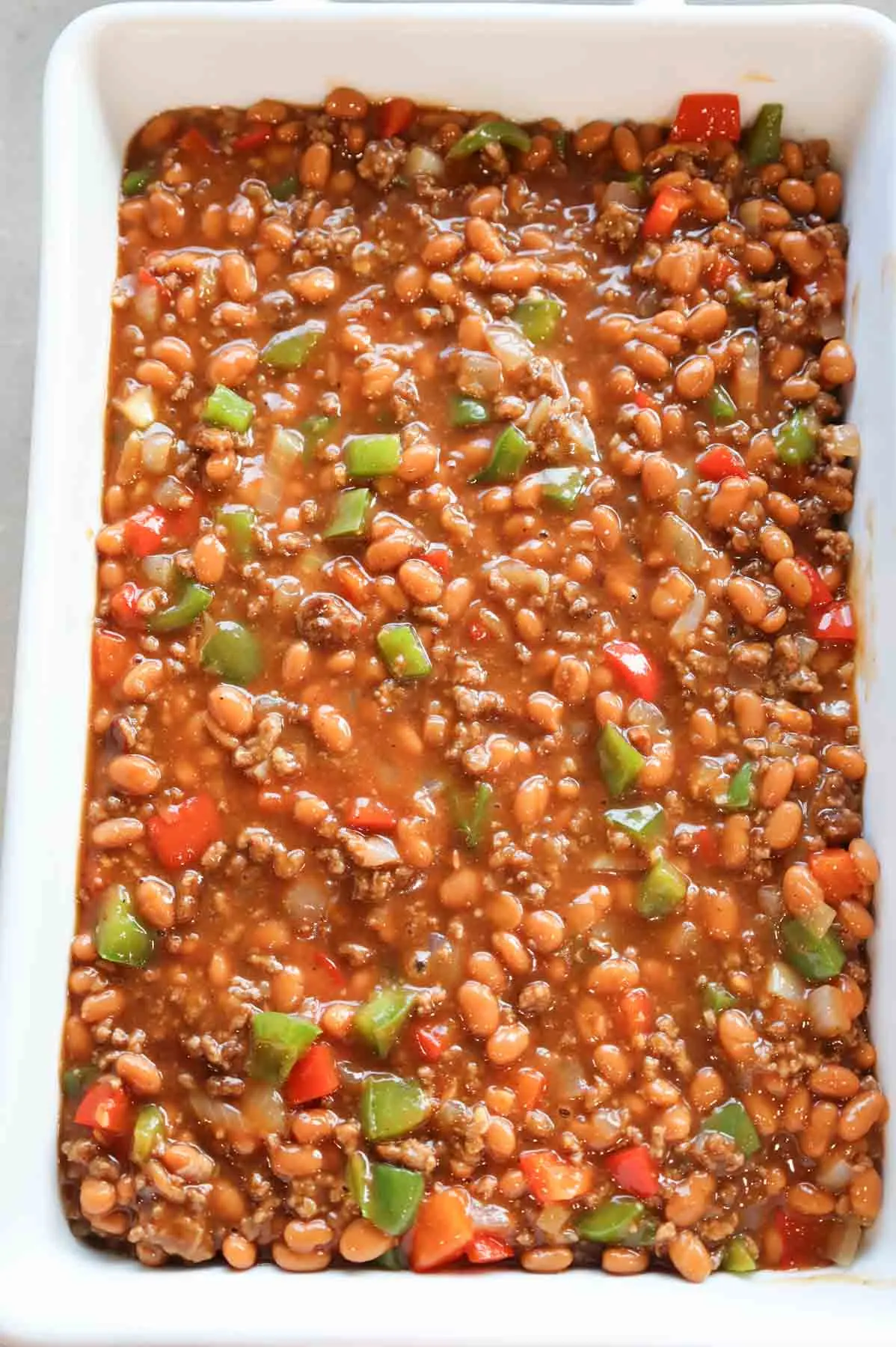 ground beef, bell peppers, baked bean and barbecue sauce mixture in a baking dish