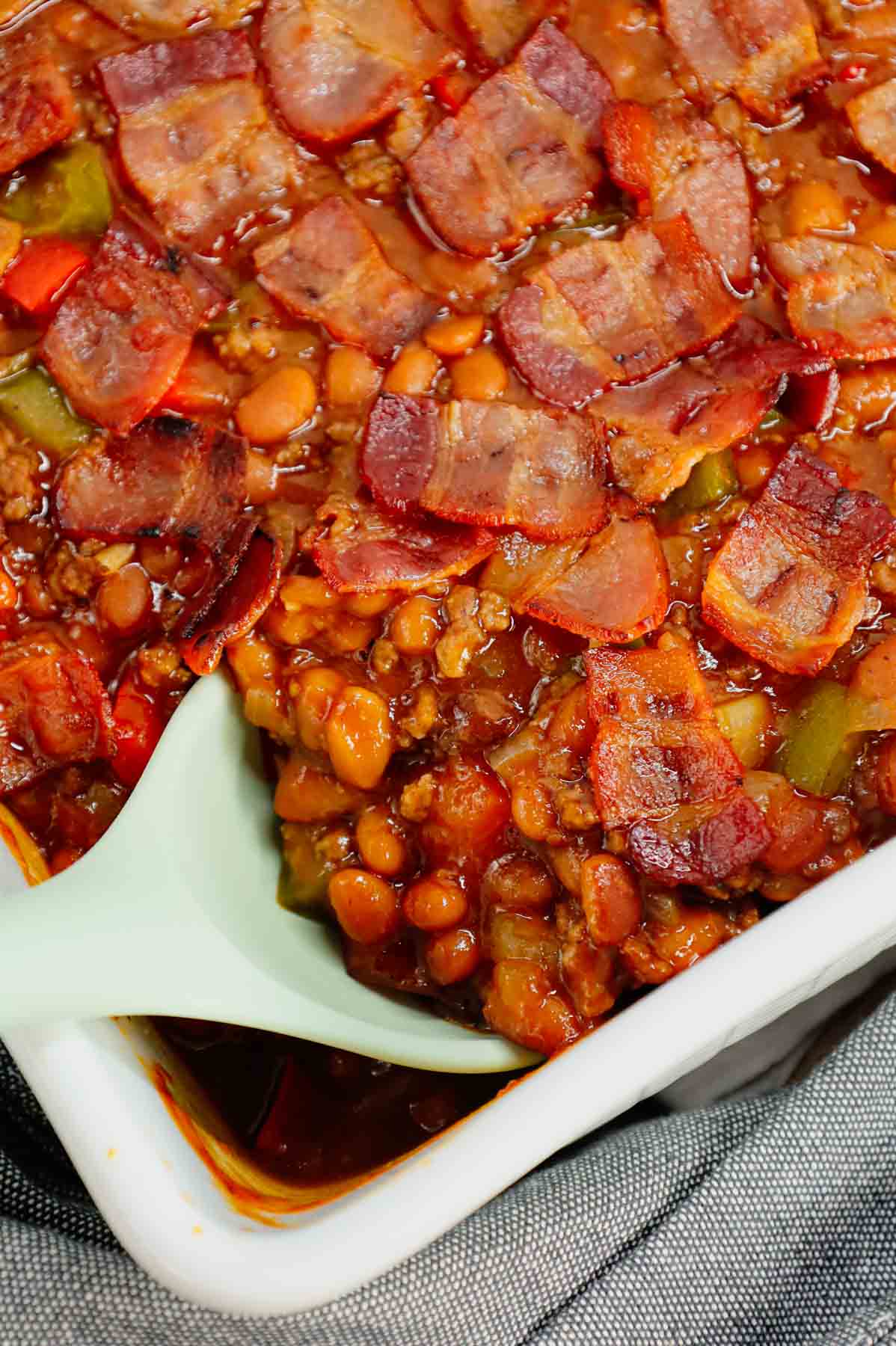 Baked Beans with Ground Beef is a hearty dinner recipe loaded with red and green bell peppers, onions, bacon and Bush's Original baked beans all baked together in a sweet and savoury barbecue sauce.