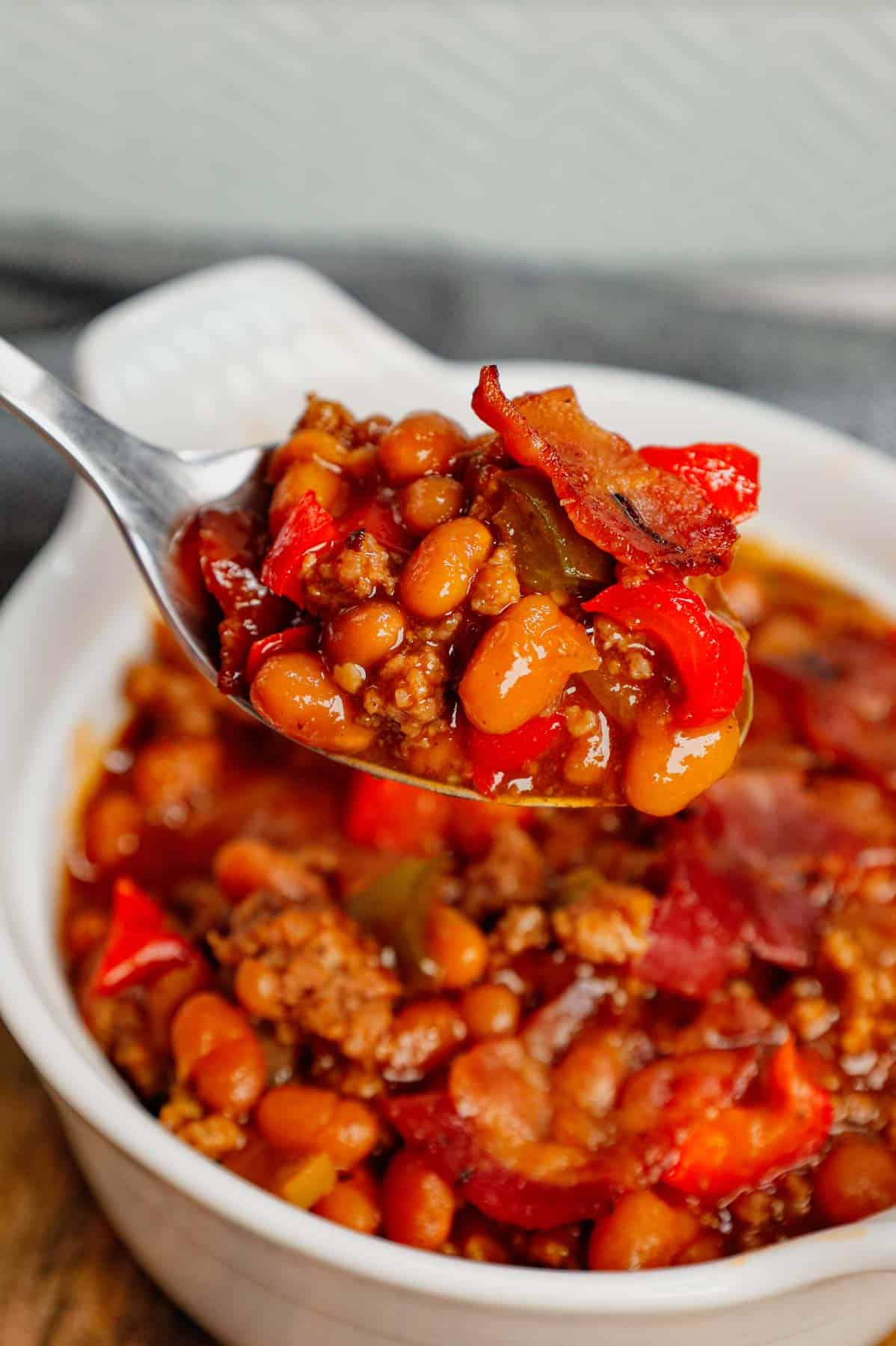 Baked Beans with Ground Beef is a hearty dinner recipe loaded with red and green bell peppers, onions, bacon and Bush's Original baked beans all baked together in a sweet and savoury barbecue sauce.