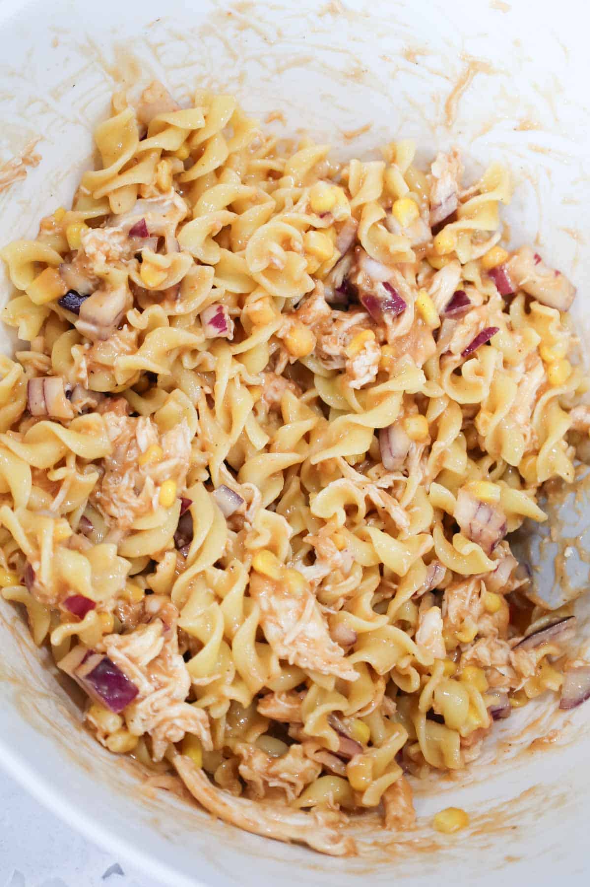 barbecue chicken and egg noodle mixture in a bowl