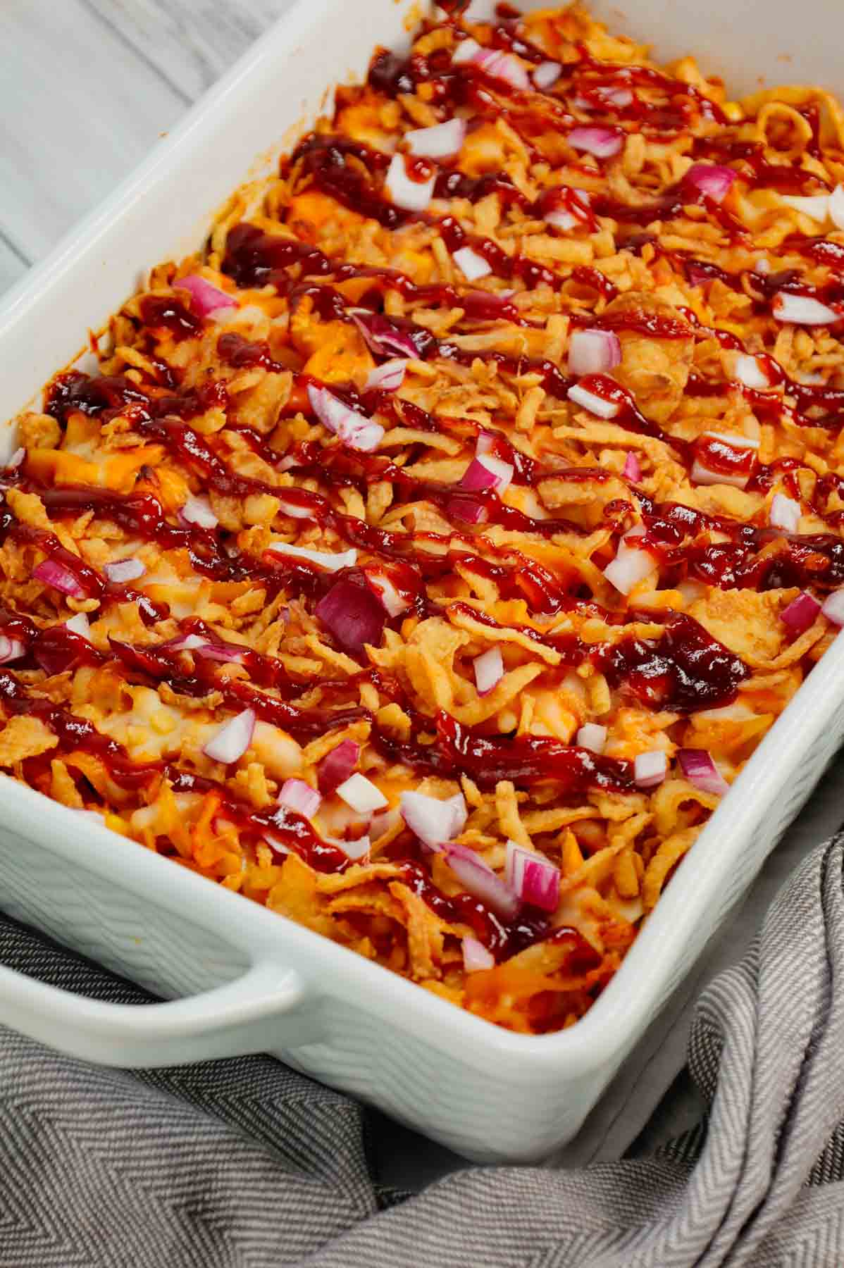 BBQ Chicken Casserole is a hearty dish loaded with egg noodles, shredded rotisserie chicken, diced red onions, corn, cream of chicken soup, barbecue sauce, cheese and French's crispy fried onions.