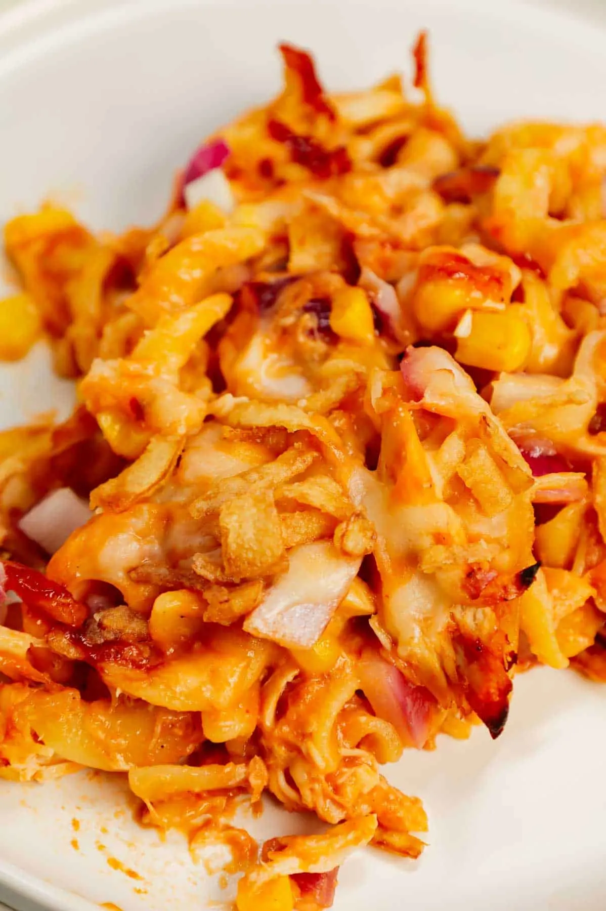 BBQ Chicken Casserole is a hearty dish loaded with egg noodles, shredded rotisserie chicken, diced red onions, corn, cream of chicken soup, barbecue sauce, cheese and French's crispy fried onions.