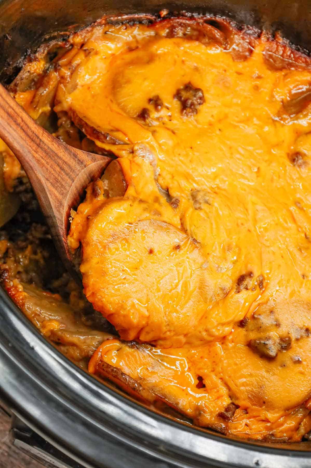 Crock Pot Hamburger Potato Casserole is a hearty slow cooker dinner loaded with ground beef, sliced potatoes, sliced onions, cheddar soup, cream of mushroom soup and shredded cheddar cheese.