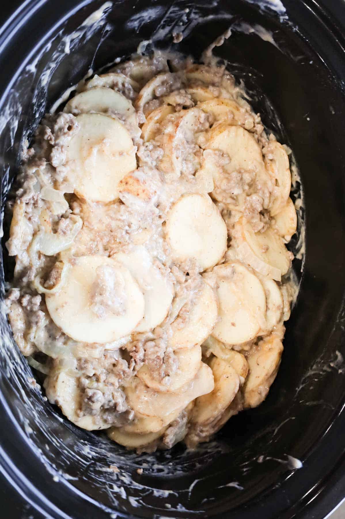 creamy ground beef and sliced potato mixture in a crock pot