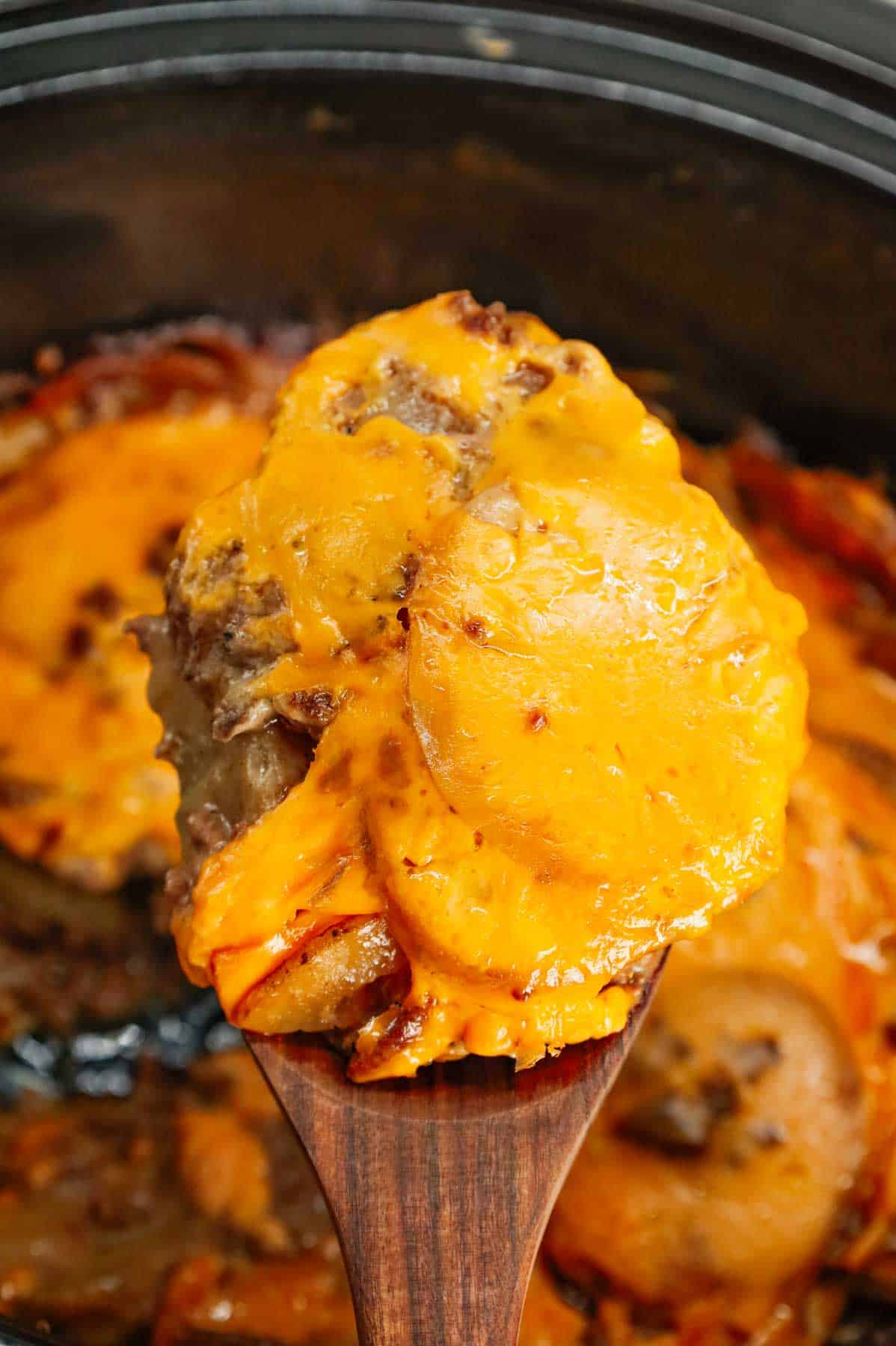 Crock Pot Hamburger Potato Casserole is a hearty slow cooker dinner loaded with ground beef, sliced potatoes, sliced onions, cheddar soup, cream of mushroom soup and shredded cheddar cheese.